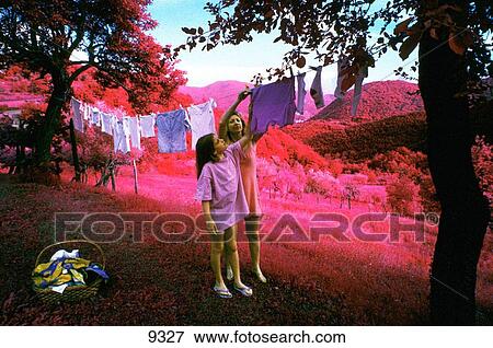 Mother and daughter hanging laundry View Large Photo Image Stock Photo - Mother and daughter hanging laundry. Fotosearch