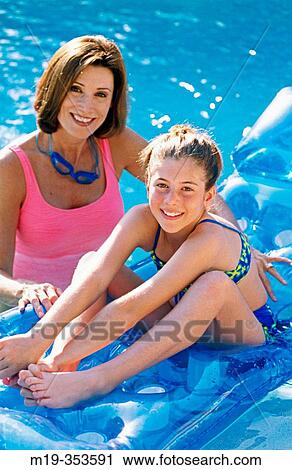 Mother and daughter having fun in the swimming pool View Large Photo Image Stock Image - Mother and daughter having fun in the swimming pool. Fotosearch