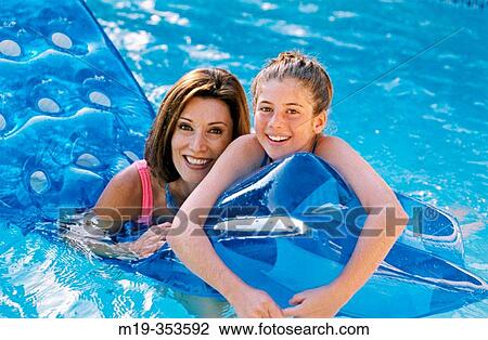 Mother and daughter having fun in the swimming pool View Large Photo Image Stock Image - Mother and daughter having fun in the swimming pool. Fotosearch
