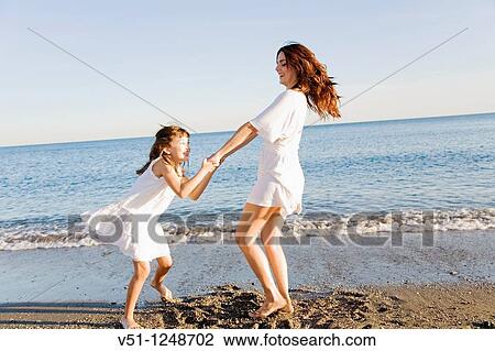 Mother and daughter having fun in the beach View Large Photo Image Stock Image - Mother and daughter having fun in the beach. Fotosearch