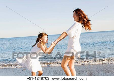 Mother and daughter having fun in the beach View Large Photo Image Stock Image - Mother and daughter having fun in the beach. Fotosearch