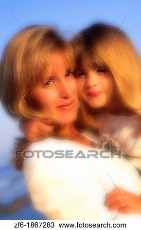 Mother and daughter hugging on the beach View Large Photo Image Stock Image - Mother and daughter hugging on the beach. Fotosearch