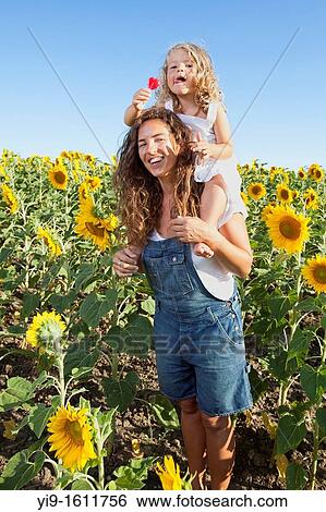 mother and daughter in a field of sunflowers View Large Photo Image Stock Photograph - mother and daughter in a field of sunflowers. Fotosearch