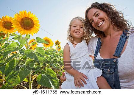 mother and daughter in a field of sunflowers View Large Photo Image Stock Photography - mother and daughter in a field of sunflowers. Fotosearch