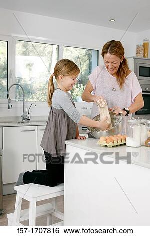 Mother and daughter in the kitchen View Large Photo Image Stock Photograph - Mother and daughter in the kitchen. Fotosearch