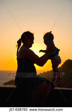 Stock Image - Mother and daughter in the sunset on the island of Kalymnos. Greece. Fotosearch