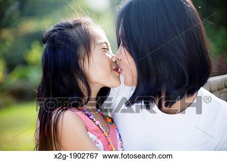 Mother and daughter kissing View Large Photo Image Stock Photo - Mother and daughter kissing. Fotosearch