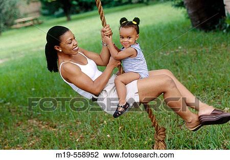 mother and daughter on a rope swing View Large Photo Image Stock Image - mother and daughter on a rope swing. Fotosearch