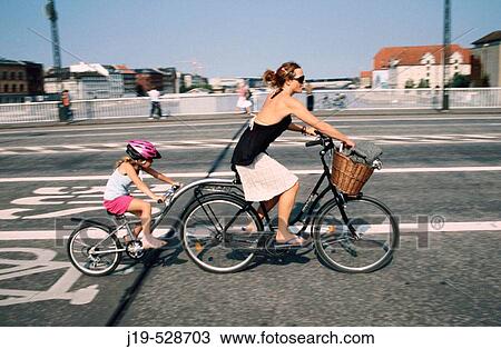 Mother and daughter on a tandem bike. Copenhagen. Denmark View Large Photo Image Stock Image - Mother and daughter on a tandem bike. Copenhagen. Denmark. Fotosearch