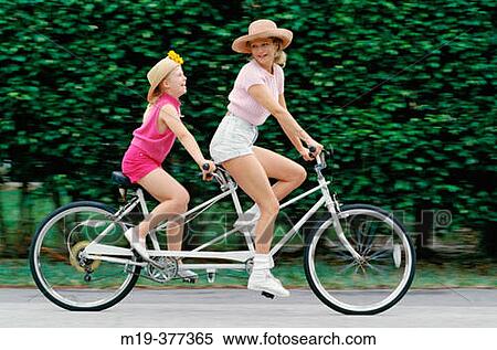 Stock Photography - mother and daughter on a tandem bike. Fotosearch