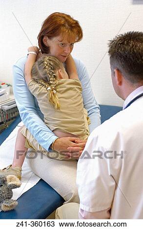 Stock Image - Mother and daughter on the pediatrist. Fotosearch