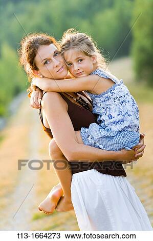 Mother and daughter outdoors View Large Photo Image Stock Image - Mother and daughter outdoors. Fotosearch