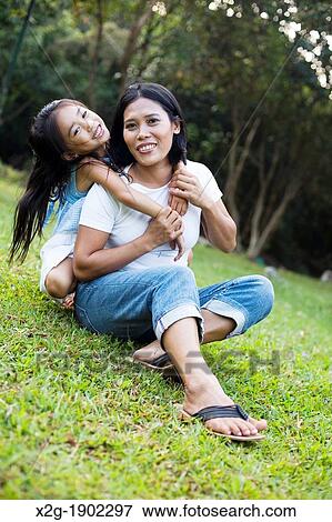 Mother and daughter playing in a garden View Large Photo Image Stock Photo - Mother and daughter playing in a garden. Fotosearch