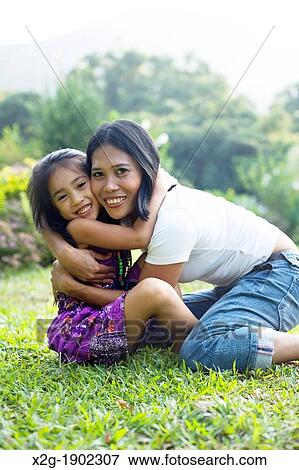 Mother and daughter playing in a garden View Large Photo Image Stock Photo - Mother and daughter playing in a garden. Fotosearch