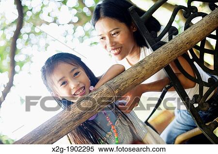 Mother and daughter playing in a garden View Large Photo Image Stock Photography - Mother and daughter playing in a garden. Fotosearch