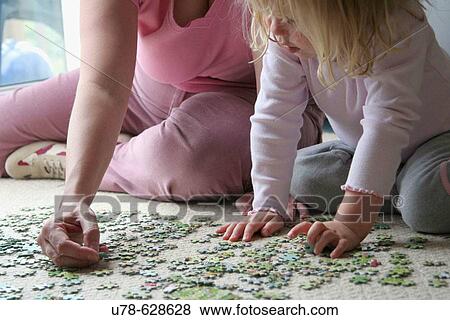 Mother and daughter playing with jigsaw puzzle View Large Photo Image Stock Photo - Mother and daughter playing with jigsaw puzzle. Fotosearch