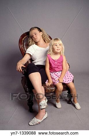 mother and daughter relaxing on an old armchair View Large Photo Image Stock Photo - mother and daughter relaxing on an old armchair. Fotosearch
