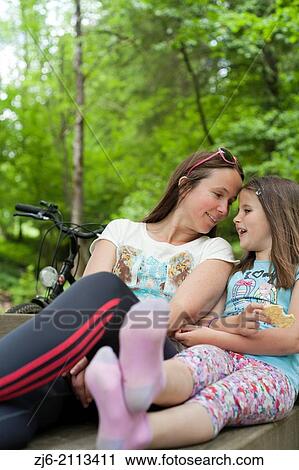 Mother and daughter resting after their bike ride. View Large Photo Image Stock Image - Mother and daughter resting after their bike ride.. Fotosearch