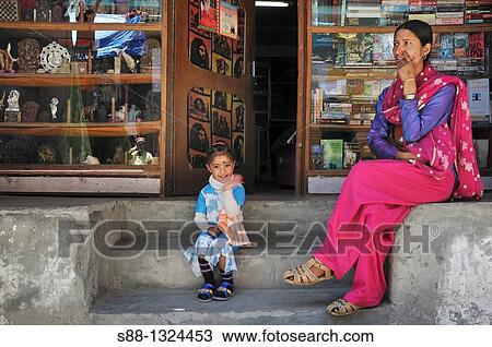 Mother and daughter sitting in front of the book shop in New Manali. Manali, Himachal Pradesh, India View Large Photo Image Stock Image - Mother and daughter sitting in front of the book shop in New Manali. Manali, Himachal Pradesh, India. Fotosearch