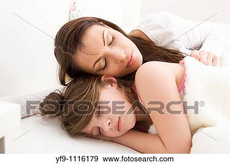 Mother and daughter sleeping in bed. View Large Photo Image Stock Photo - Mother and daughter sleeping in bed.. Fotosearch