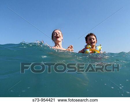 Mother and daughter swimming in the sea View Large Photo Image Stock Image - Mother and daughter swimming in the sea. Fotosearch