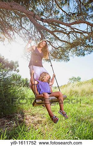 mother and daughter swinging View Large Photo Image Stock Image - mother and daughter swinging. Fotosearch