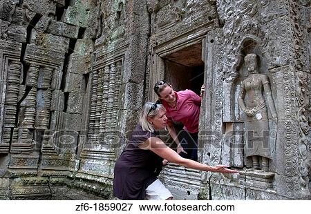 Mother and daughter tourists at temple Ta Prohm near Anglor Wat in Siem Reap Cambodia Asia View Large Photo Image Stock Photo - Mother and daughter tourists at temple Ta Prohm near Anglor Wat in Siem Reap Cambodia Asia. Fotosearch