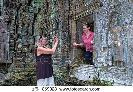 Mother and daughter tourists at temple Ta Prohm near Anglor Wat in Siem Reap Cambodia Asia View Large Photo Image Stock Photo - Mother and daughter tourists at temple Ta Prohm near Anglor Wat in Siem Reap Cambodia Asia. Fotosearch