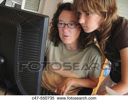Mother and daughter with desktop computer View Large Photo Image Stock Photography - Mother and daughter with desktop computer. Fotosearch