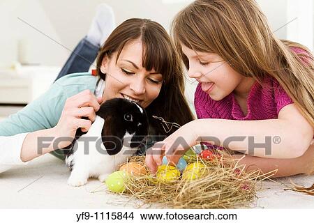 Mother and daughter with Easter Eggs and rabbit. View Large Photo Image Picture - Mother and daughter with Easter Eggs and rabbit.. Fotosearch