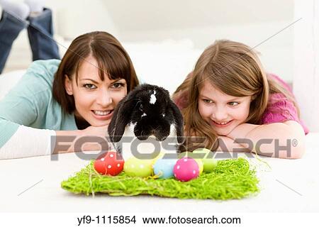 Mother and daughter with Easter Eggs and rabbit. View Large Photo Image Picture - Mother and daughter with Easter Eggs and rabbit.. Fotosearch
