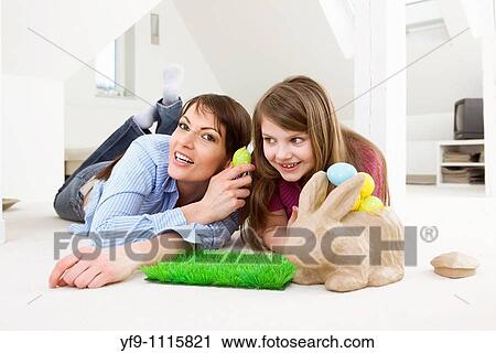 Mother and daughter with Easter eggs and rabbit. View Large Photo Image Stock Image - Mother and daughter with Easter eggs and rabbit.. Fotosearch