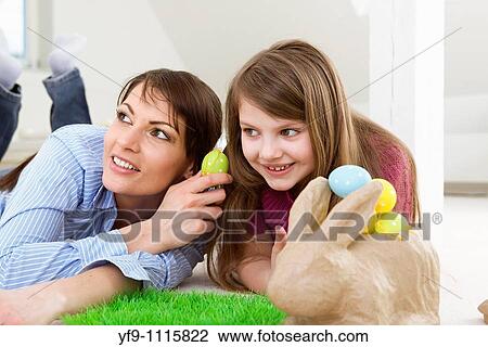 Mother and daughter with Easter eggs and rabbit. View Large Photo Image Stock Image - Mother and daughter with Easter eggs and rabbit.. Fotosearch