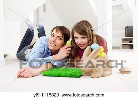 Mother and daughter with Easter eggs and rabbit. View Large Photo Image Stock Image - Mother and daughter with Easter eggs and rabbit.. Fotosearch