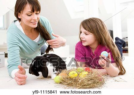 Mother and daughter with Easter Eggs and rabbit. View Large Photo Image Stock Image - Mother and daughter with Easter Eggs and rabbit.. Fotosearch