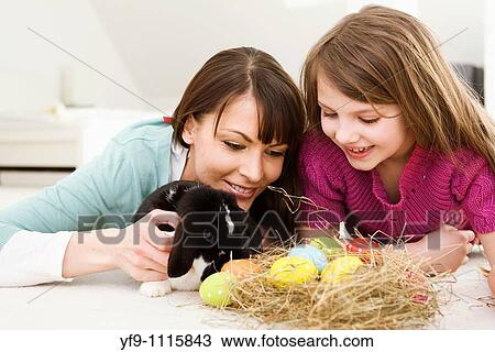 Mother and daughter with Easter Eggs and rabbit. View Large Photo Image Stock Image - Mother and daughter with Easter Eggs and rabbit.. Fotosearch