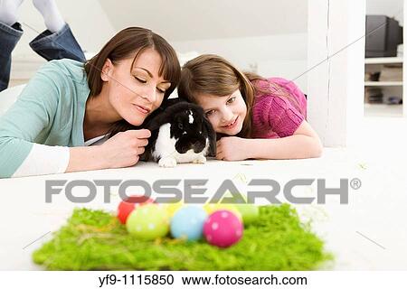 Mother and daughter with Easter Eggs and rabbit. View Large Photo Image Stock Image - Mother and daughter with Easter Eggs and rabbit.. Fotosearch