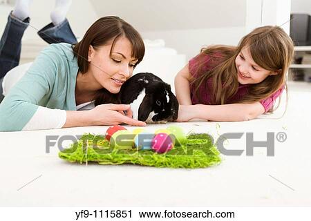 Mother and daughter with Easter Eggs and rabbit. View Large Photo Image Stock Image - Mother and daughter with Easter Eggs and rabbit.. Fotosearch