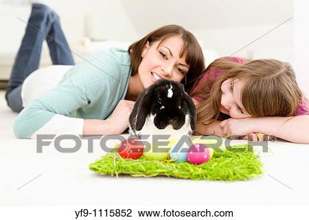 Mother and daughter with Easter Eggs and rabbit. View Large Photo Image Stock Image - Mother and daughter with Easter Eggs and rabbit.. Fotosearch