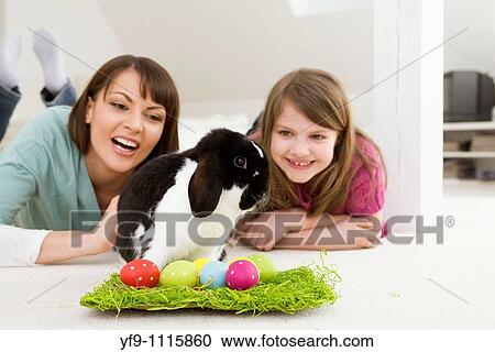 Mother and daughter with Easter Eggs and rabbit. View Large Photo Image Stock Image - Mother and daughter with Easter Eggs and rabbit.. Fotosearch