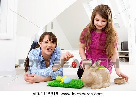 Mother and daughter with Easter eggs and rabbit. View Large Photo Image Stock Photo - Mother and daughter with Easter eggs and rabbit.. Fotosearch