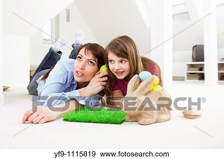 Mother and daughter with Easter eggs and rabbit. View Large Photo Image Stock Photo - Mother and daughter with Easter eggs and rabbit.. Fotosearch