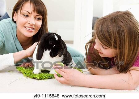 Mother and daughter with Easter Eggs and rabbit. View Large Photo Image Stock Photo - Mother and daughter with Easter Eggs and rabbit.. Fotosearch