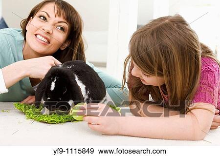 Mother and daughter with Easter Eggs and rabbit. View Large Photo Image Stock Photo - Mother and daughter with Easter Eggs and rabbit.. Fotosearch