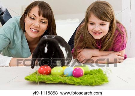 Mother and daughter with Easter Eggs and rabbit. View Large Photo Image Stock Photo - Mother and daughter with Easter Eggs and rabbit.. Fotosearch