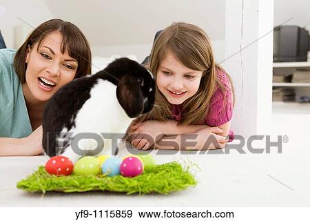 Mother and daughter with Easter Eggs and rabbit. View Large Photo Image Stock Photo - Mother and daughter with Easter Eggs and rabbit.. Fotosearch
