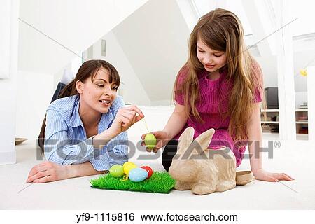 Mother and daughter with Easter eggs and rabbit. View Large Photo Image Stock Photograph - Mother and daughter with Easter eggs and rabbit.. Fotosearch