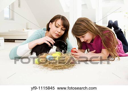Mother and daughter with Easter Eggs and rabbit. View Large Photo Image Stock Photography - Mother and daughter with Easter Eggs and rabbit.. Fotosearch