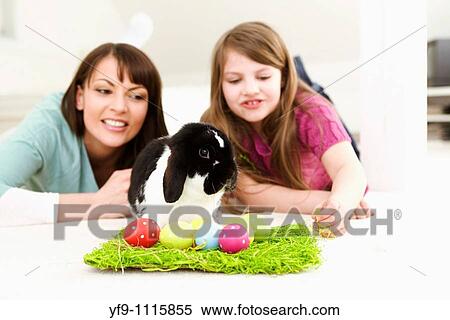 Mother and daughter with Easter Eggs and rabbit. View Large Photo Image Stock Photography - Mother and daughter with Easter Eggs and rabbit.. Fotosearch