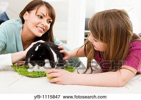 Mother and daughter with rabbit. View Large Photo Image Stock Photo - Mother and daughter with rabbit.. Fotosearch